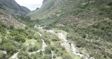 Aerial view of landscapes of Chupani village in middle of the Peruvian Andes. Small community in the Sacred Valley with some ruins and river.