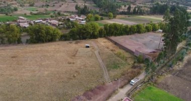 Aerial view of rural fields in Calca city in the Sacred Valley in Cusco Peru. Peruvian high Andes during dry season.