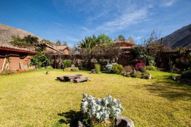 View of garden backyard in a rural house in the Peruvian Andes. Countryside garden house with grass.