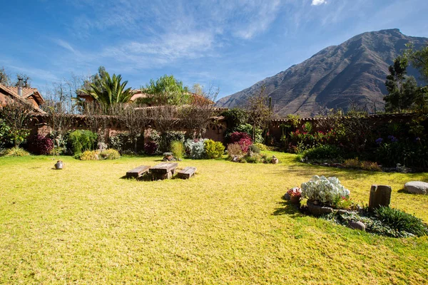 View of garden backyard in a rural house in the Peruvian Andes. Countryside garden house with grass.