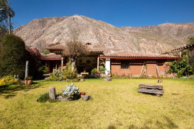 View of garden backyard in a rural house in the Peruvian Andes. Countryside garden house with grass.