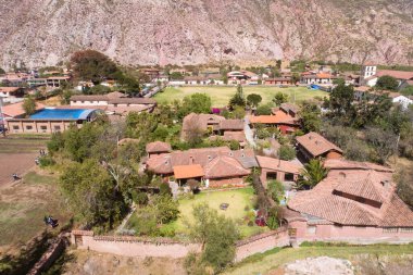 Aerial view of a rural house in the countryside of Cusco Peru. House in Yucay town with roof tiles.