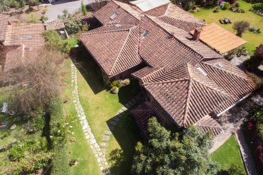 Aerial view of a rural house in the countryside of Cusco Peru. House in Yucay town with roof tiles.