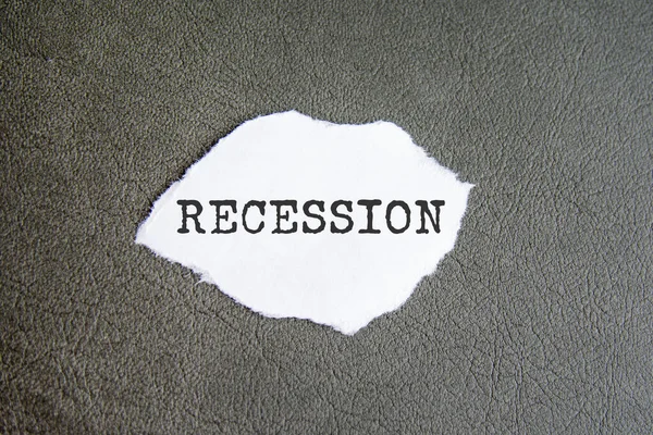 Recessie teken op het gescheurde papier op de grijze achtergrond — Stockfoto