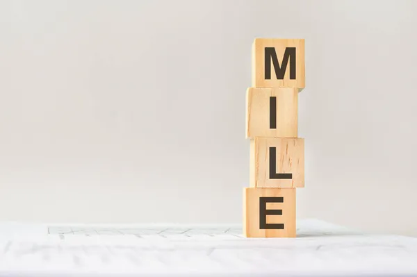 Four Wood Cubes Word Mile Background White Financial Statements Strong — Stock Photo, Image