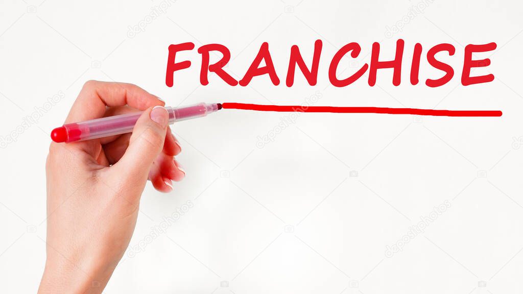 left hand writing inscription franchise with red color marker, concept, stock image