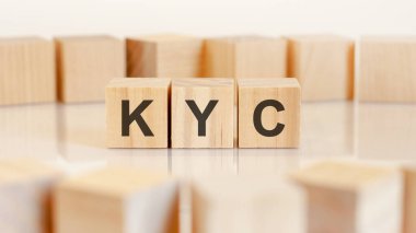 word KYC is written on wooden cubes standing in a row. around the blocks on a light background. can be used for business and financial concepts. KYC short for know your customer