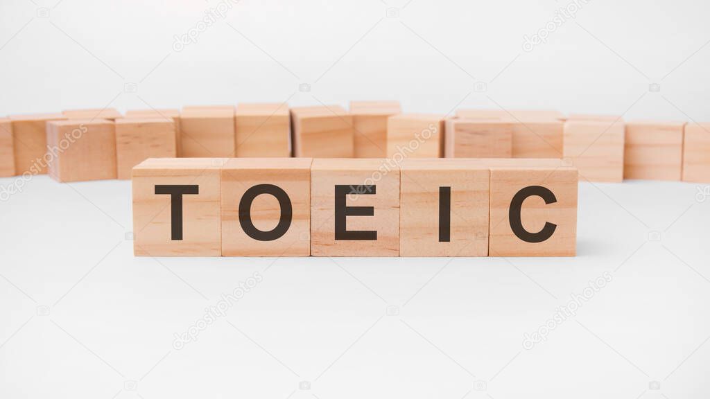 word TOEIC is made of wooden building blocks lying on the table and on a light background. concept. TOEIC - short for Test of English for International Communication