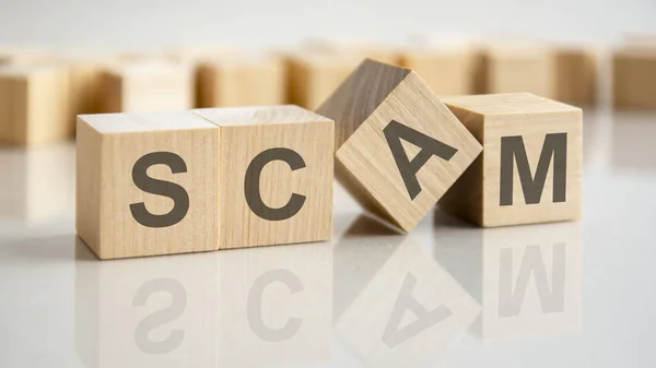 Four Wooden Blocks Letters Scam Bright Surface Gray Table Inscription — Stock Photo, Image