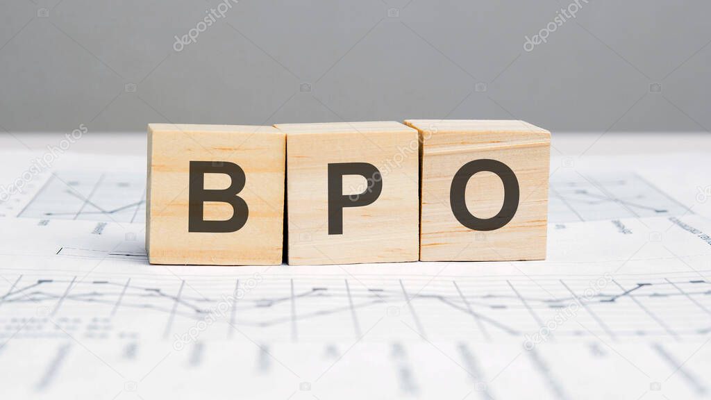a wooden blocks with the letters BPO written on it on a white background. BPO - short for Business Process Outsourcing