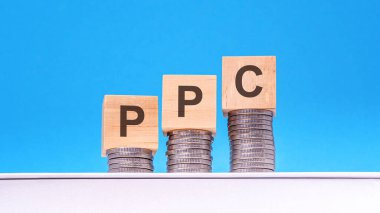 ppc - Her Tıklama Başına Öde - bozuk para, mavi arkaplan, iş konsepti içeren tahta küpler üzerine metin