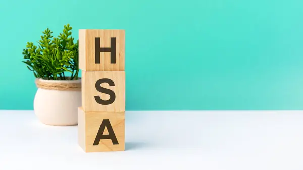 hsa - word from wooden blocks with letters. business concept on green background. copy space available. hsa - short for Health Savings Account