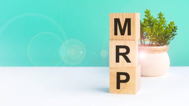 mrp - acronym from wooden blocks with letters, Marketing Research Planning concept on green background clipart