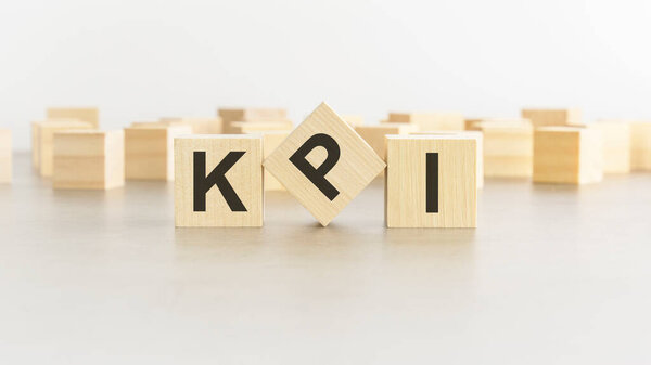 KPI - Key Performance Indicators - letter pices on the wooden cubes, white background