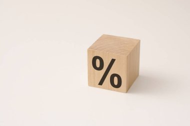 Beyaz arka plandaki yüzde işaretini değiştirmek için tahta bir kübik bloğu çevirmek. kredi geçmişi ve satış konsepti