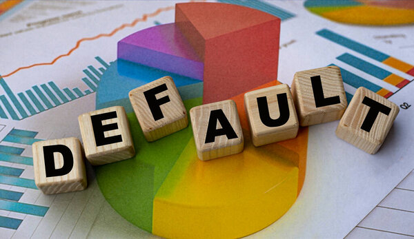 The concept of the word DEFAULT on cubes against the background of the graph