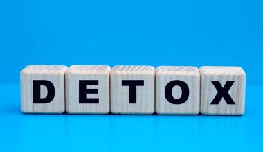 Mavi arkaplandaki tahta küplerin DETOX sözcüğünü kavrayın