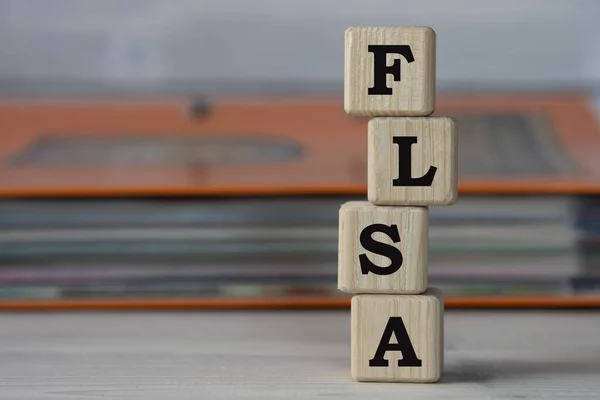 Flsa Fair Labor Standards Act Акроним Деревянных Кубиках Фоне Папки — стоковое фото