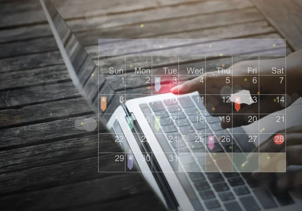 Business people using Laptop with Appointment Reminder to Calendar and Organizer Agenda.Event planners use timetables and agendas to arrange and schedule events. taking notes on his virtual calendar.