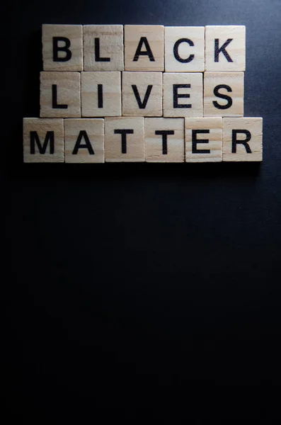 Text message Black lives matter for protest action. Selective focus on Lettering Black lives matter. Banner on black background with copy space. Concept of Human rights.