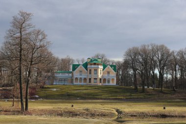 Güneşin ışınlarında güzel bir saray kulübesi St. Petersburg 'daki gizemli Peterhof Park' ta ilkbaharın başlarında bulutlu bir gökyüzüne karşı.