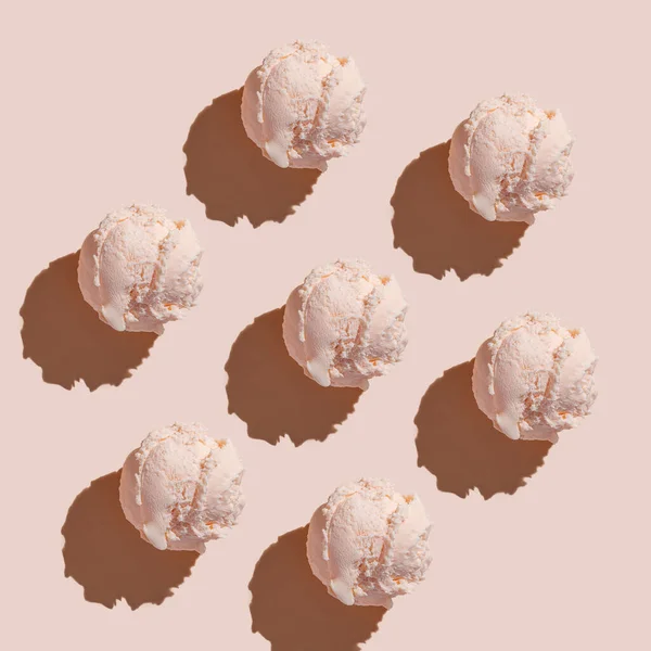 Ice cream balls pattern with copy space on a pastel pink background. Summertime, dessert minimal concept. Top view. Raspberry gelato, hard light