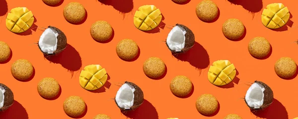 Mango Cookies with coconut in pattern on the orange background. No sugar. Top view  .Healthy and tasty Cookies with protein. Continous pattern, isolate, flat lay, hard light, minimal