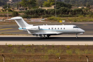 Luqa, Malta - August 19, 2022: Bombardier Challenger 300 (BD-100-1A10) touching down on runway 31.