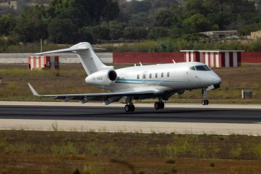 Luqa, Malta - August 19, 2022: Bombardier Challenger 300 (BD-100-1A10) touching down on runway 31.