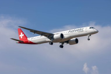 Luqa, Malta - August 12, 2022: Helvetic Airways Embraer 195 E2 STD (ERJ-190-400STD) (REG: HB-AZJ) landing with some bad weather in the background.