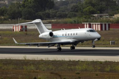 Luqa, Malta - August 19, 2022: Bombardier Challenger 300 (BD-100-1A10) (REG: OK-AOA) touching down on runway 31.