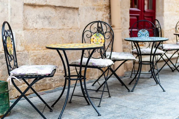Outdoor cafe in the old town. Chairs and table on empty terrace at cafe .