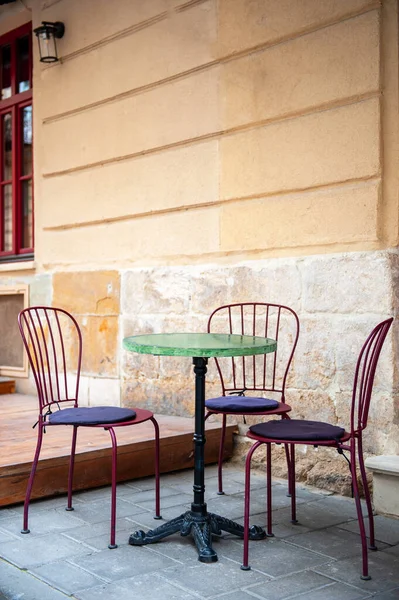 Outdoor cafe in the old town. Chairs and table on empty terrace at cafe .