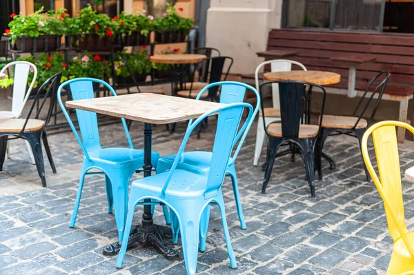 Outdoor cafe in the old town. Chairs and table on empty terrace at cafe .