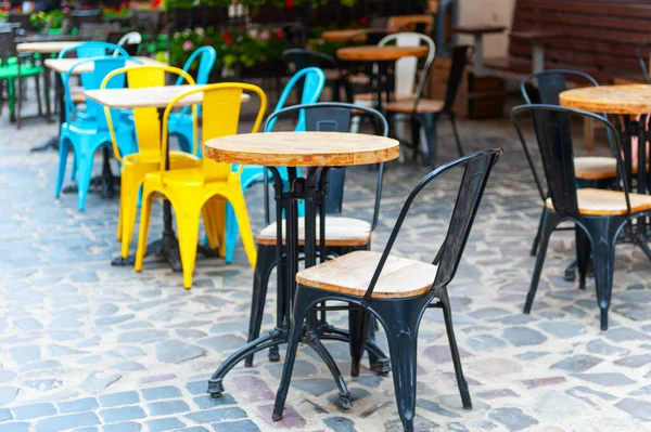 Outdoor cafe in the old town. Chairs and table on empty terrace at cafe .