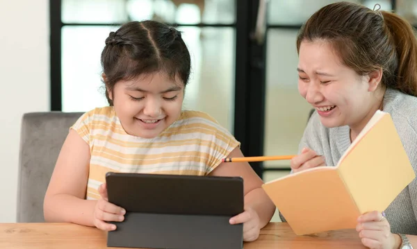 Asian girl studying privately with tutor at home, siblings teaching homework, online learning.