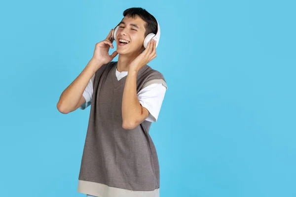 음악가. 젊은 남자, 학생, 소년 이 평상복을 입고 푸른 스튜디오 뒤에 고립되어 있는 모습. 인간의 감정 개념. — 스톡 사진