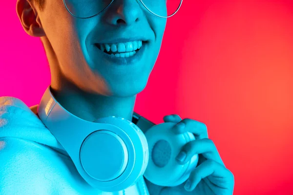 Immagine ritagliata di giovane studente o ragazzo in abiti casual sorridente isolato sul backgroud studio magenta in neon. Concetto di emozioni umane. — Foto Stock