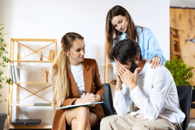 Psikolog randevusunda. Evli çift, üzgün, depresif erkek ve kadın aile sorununu çözmek için danışmanla buluşuyor.