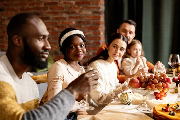 Happy Thanksgiving dinner party with family and friends with turkey and holiday traditional food, dishes on table. — Stock Photo, Image