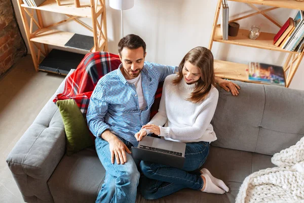 Pareja casada sonriente pasando tiempo juntos en casa, adentro. Pareja de mediana edad sentados juntos. Concepto de familia, relación — Foto de Stock