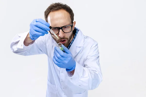 Hög vinkel syn på ung kemist, läkare bedriver kemisk forskning isolerad på vit bakgrund. Begreppet farmakologi. — Stockfoto