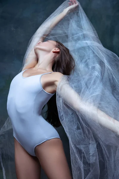 Primer plano de la joven hermosa chica, bailarina posando con tela transparente blanca aislada sobre fondo oscuro estudio vintage. —  Fotos de Stock