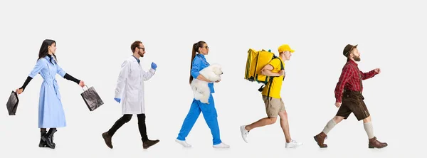 Group of gender mixed people with different professions, jobs walking ahead isolated on white studio background. — Stock Photo, Image