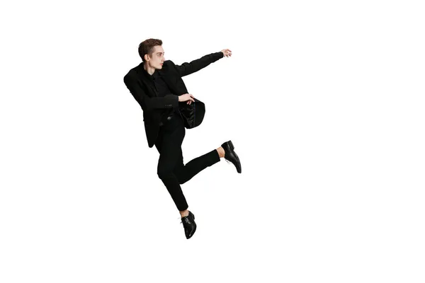 Young man in black business suit dancing isolated on white background. Art, motion, action, flexibility, inspiration concept. — Stock Photo, Image