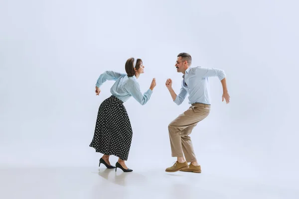 Two dancers, young man and woman in old-school fashioned attire dancing rock-and-roll isolated on white background — Stock Photo, Image