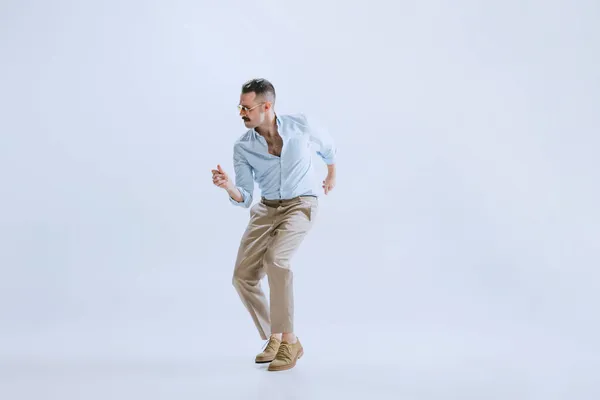 Portrai of young man, hipster or dandy dancing rock-and-roll or swing isolated on white background. retro vintage style — Stock Photo, Image