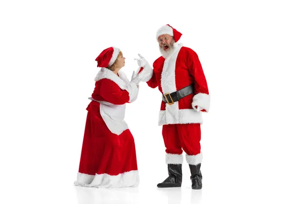 Wütender älterer Mann, Weihnachtsmann schreit Frau an, Missis Claus isoliert auf weißem Hintergrund. — Stockfoto