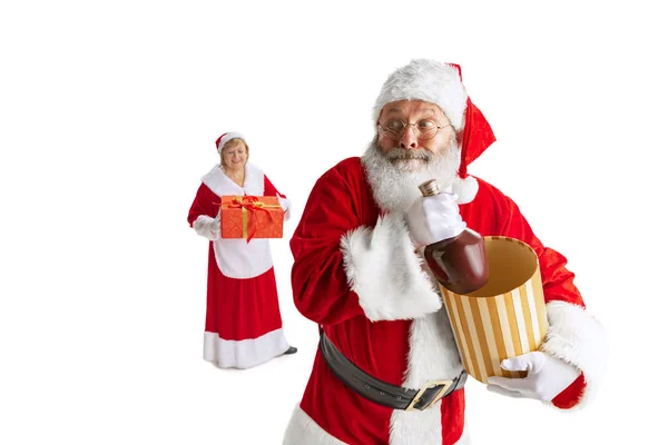 Szczęśliwy uśmiechnięty starzec w kostiumie Świętego Mikołaja i urocza kobieta, Missis Claus z pudełkami na prezenty izolowane na białym tle. — Zdjęcie stockowe