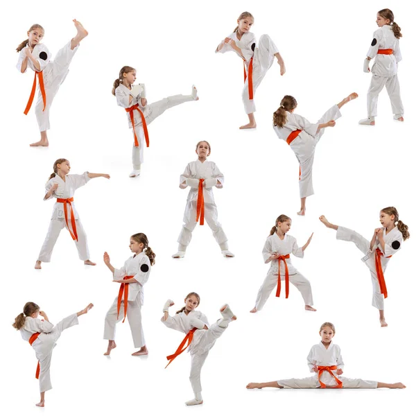 Utveckling av rörelserna inom idrottsträning. Liten flicka, ung karate utbildning ensam isolerad över vit bakgrund. — Stockfoto